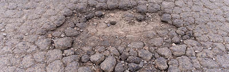 Photo of a pothole in a local access road